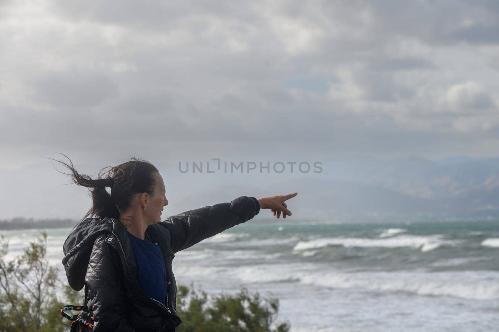 portrait of a woman pointing to the Mediterranean Sea in Cyprus 4