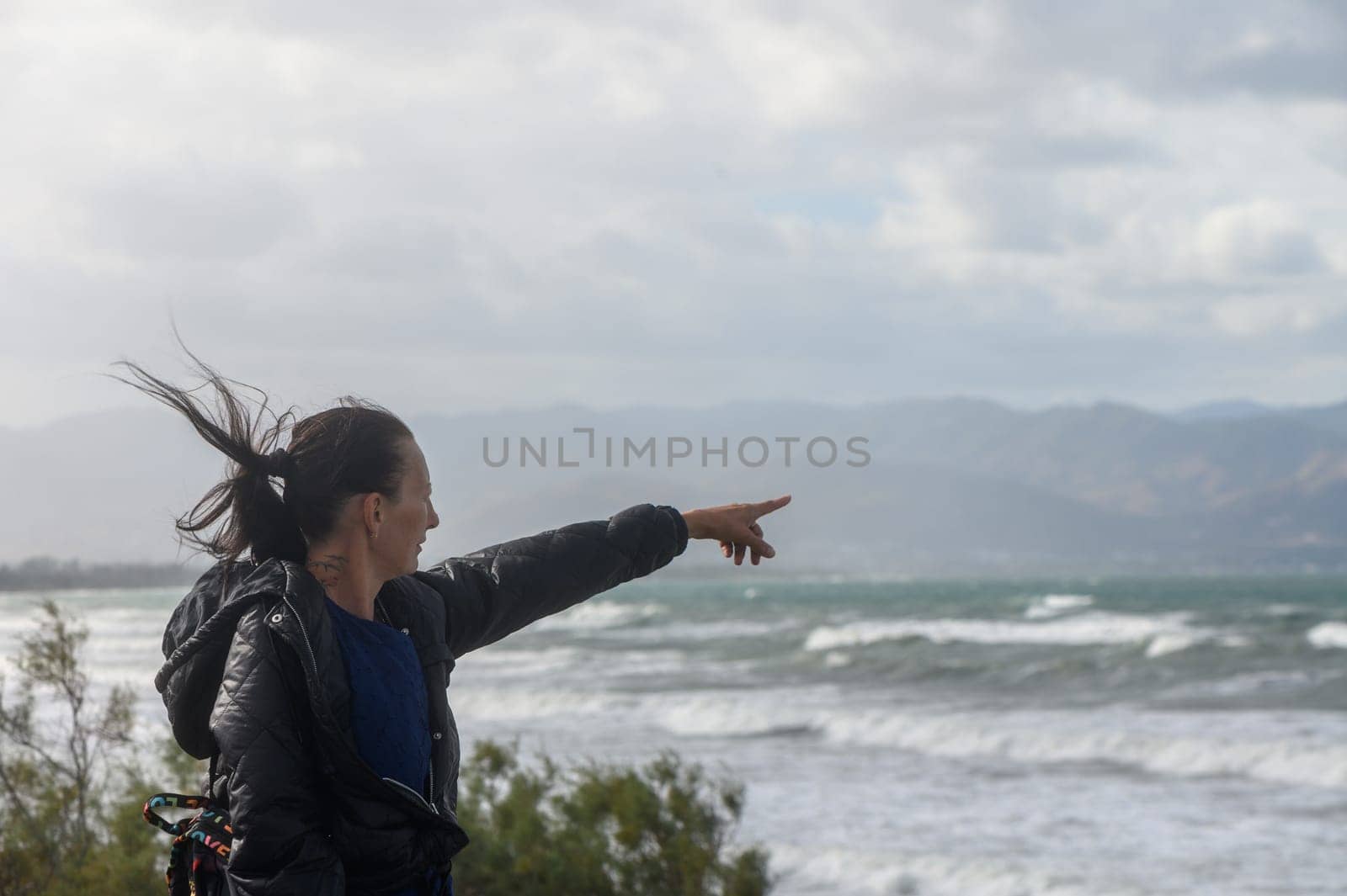 portrait of a woman pointing to the Mediterranean Sea in Cyprus 1
