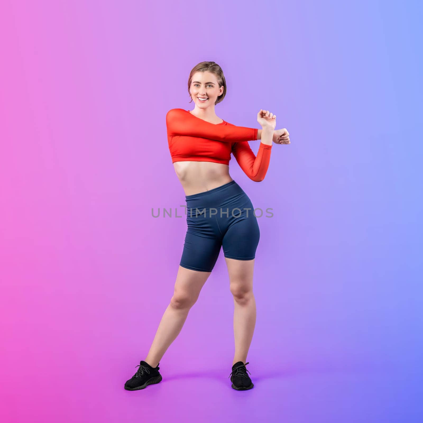 Full body length gaiety shot athletic and sporty young woman with fitness warmup and stretching body for pre exercise posture on isolated background. Healthy active and body care lifestyle.