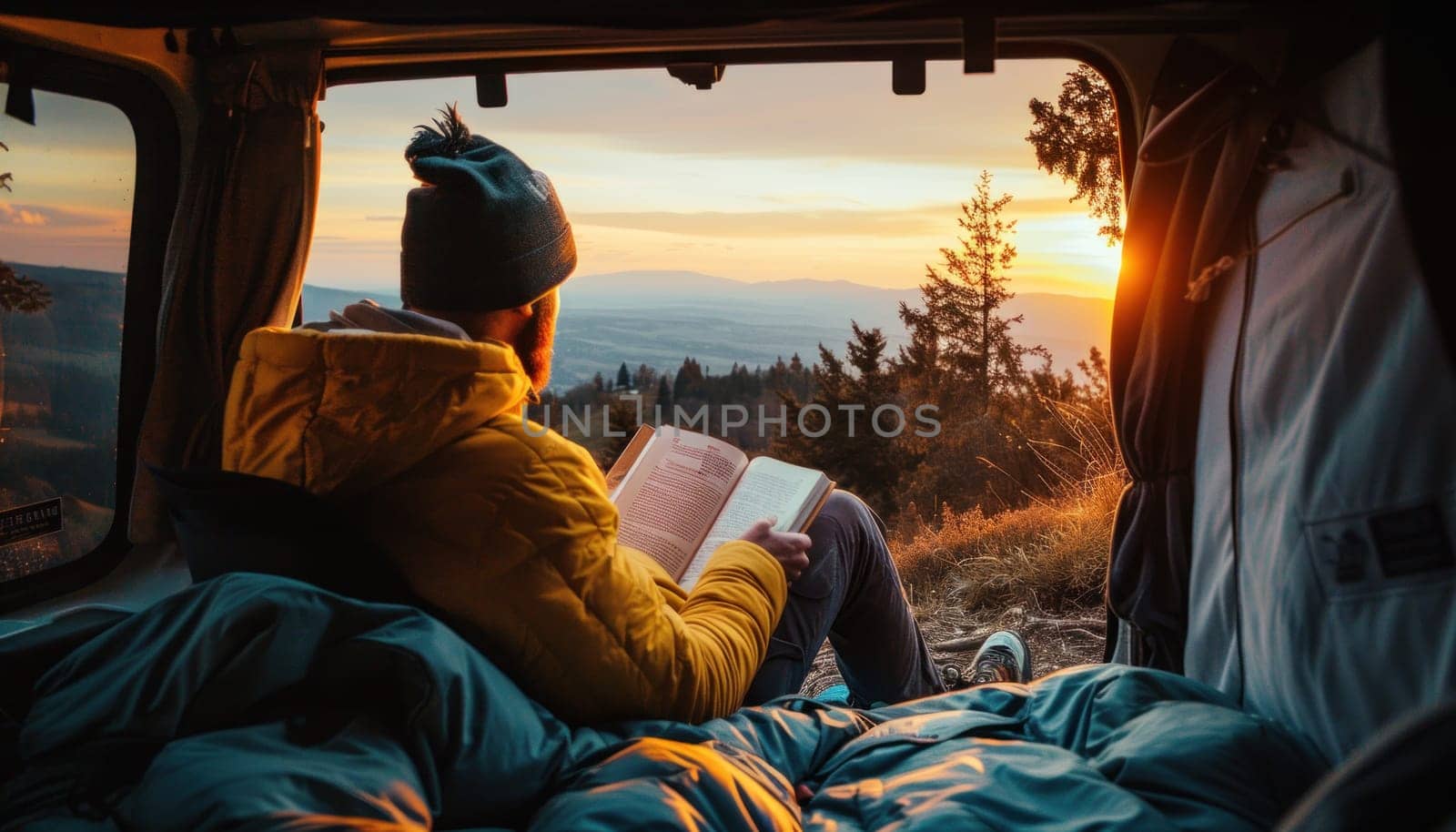 A man sits in the back of his car reading a book campsite at sunset. Generative AI.