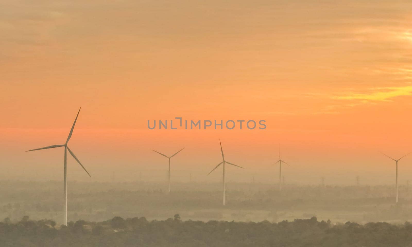Landscape wind farm with sunrise sky. Sustainable renewable energy. Wind power for sustainability. Green technology. Sustainable development. Wind turbines generate electricity. Energy sustainability. by Fahroni