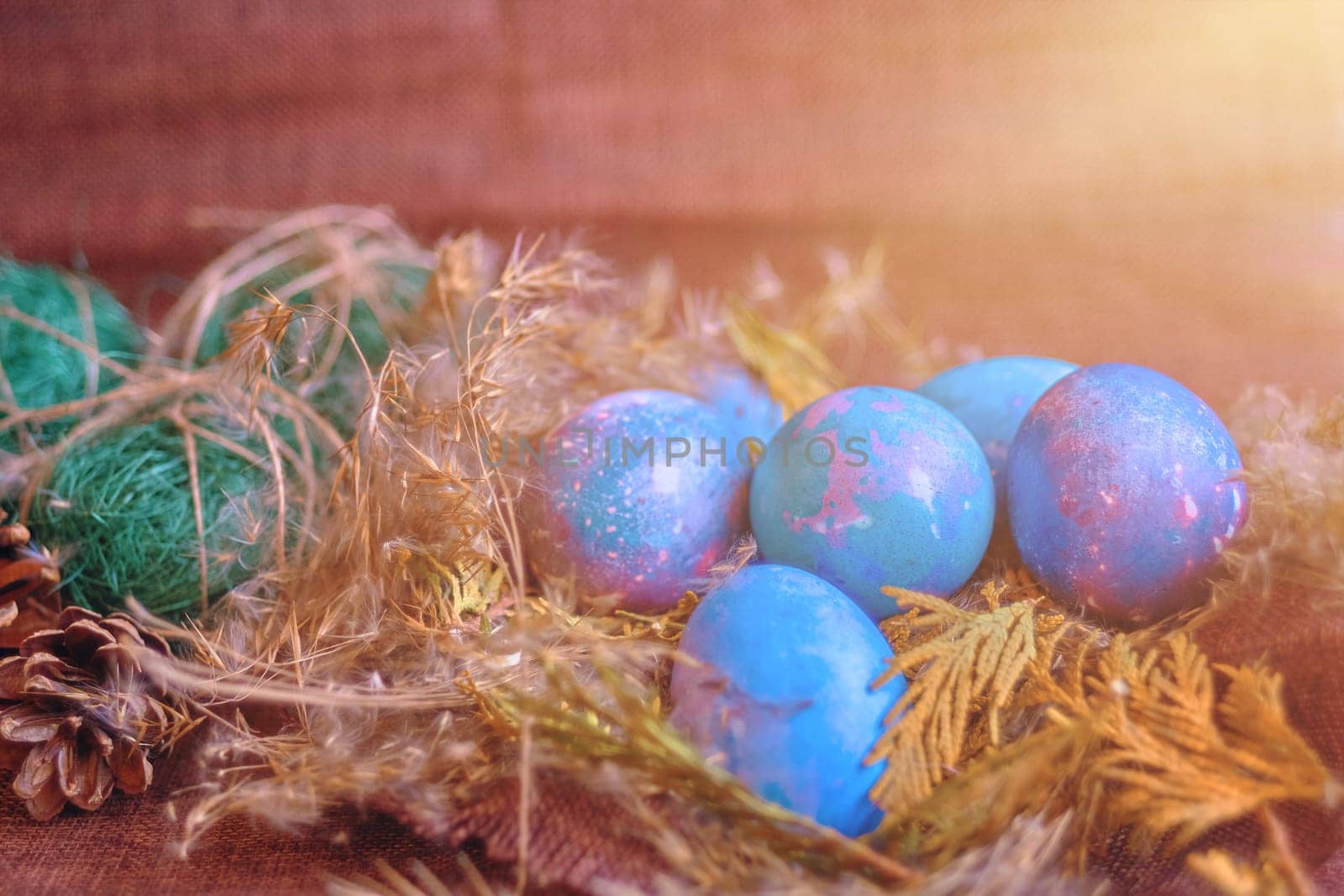 space galactic Easter eggs in nest next to cone and green filler