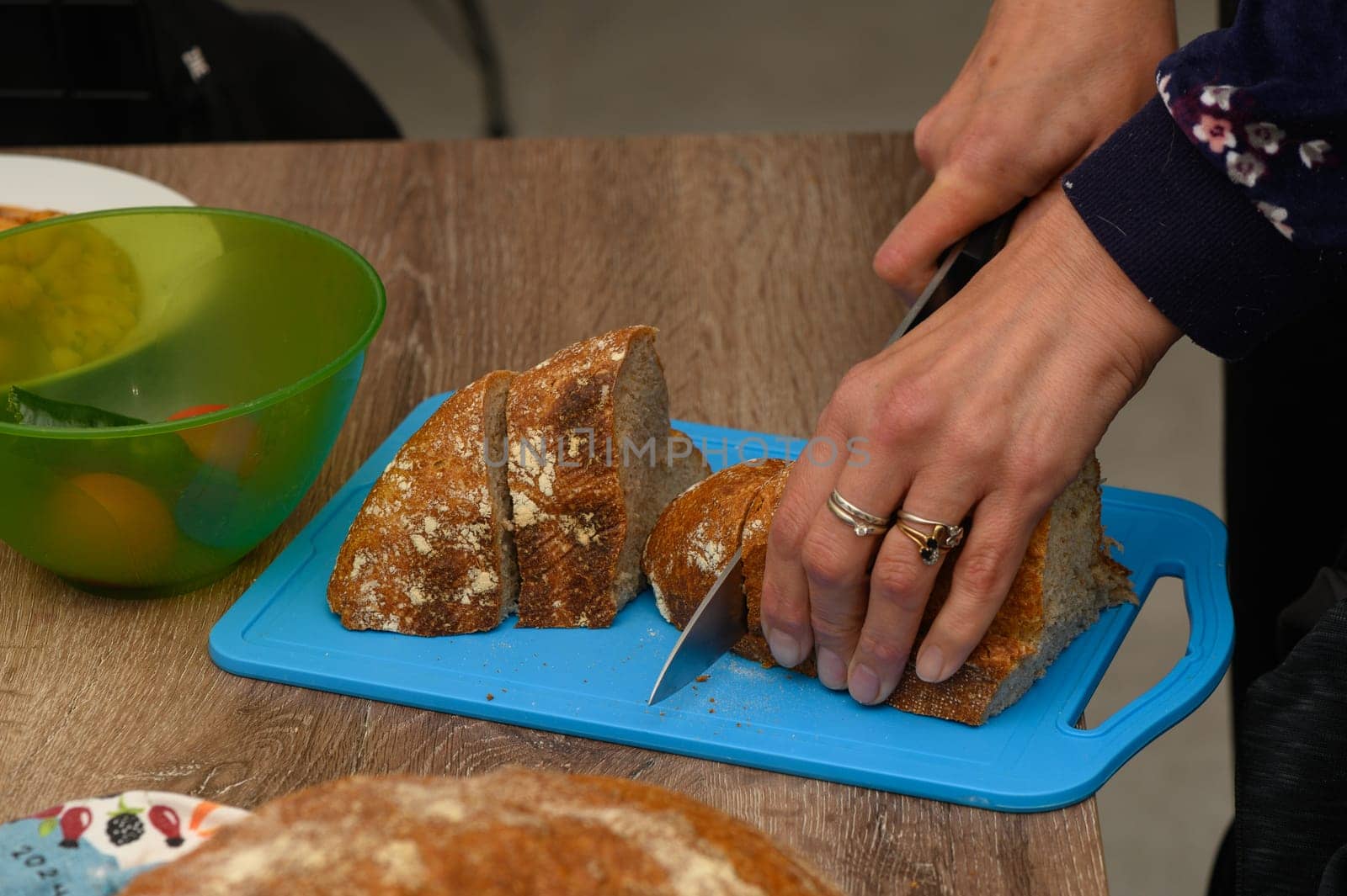 woman cutting freshly baked homemade bread in the kitchen 5