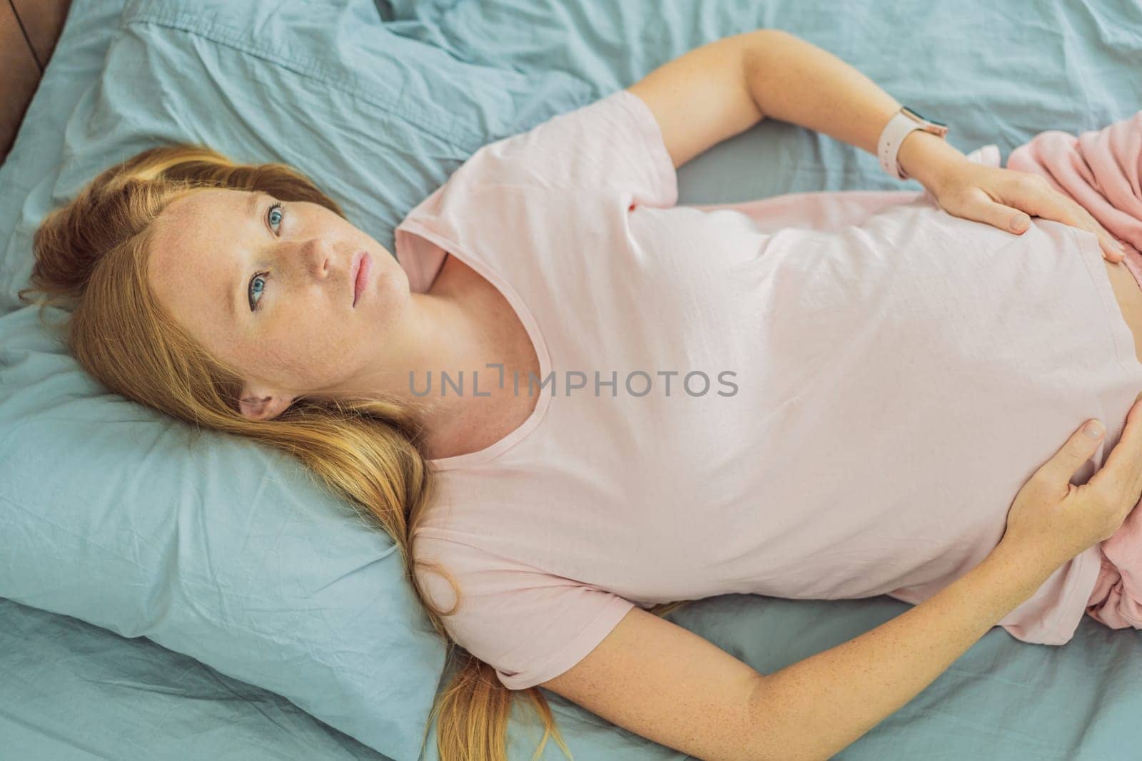 Sleep-deprived pregnant woman struggles with insomnia, navigating the challenges of restlessness during pregnancy by galitskaya