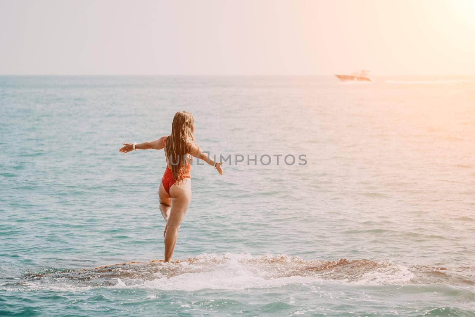 Woman sea yoga. Happy woman meditating in yoga pose on the beach, ocean and rock mountains. Motivation and inspirational fit and exercising. Healthy lifestyle outdoors in nature, fitness concept. by panophotograph