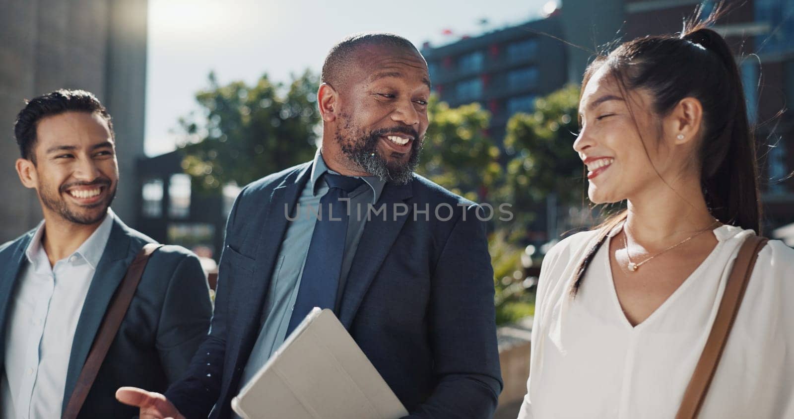 Business people, travel and group in city with discussion on morning commute, partnership and walking. Employees, man and woman with conversation, collaboration and networking outdoor in urban town by YuriArcurs