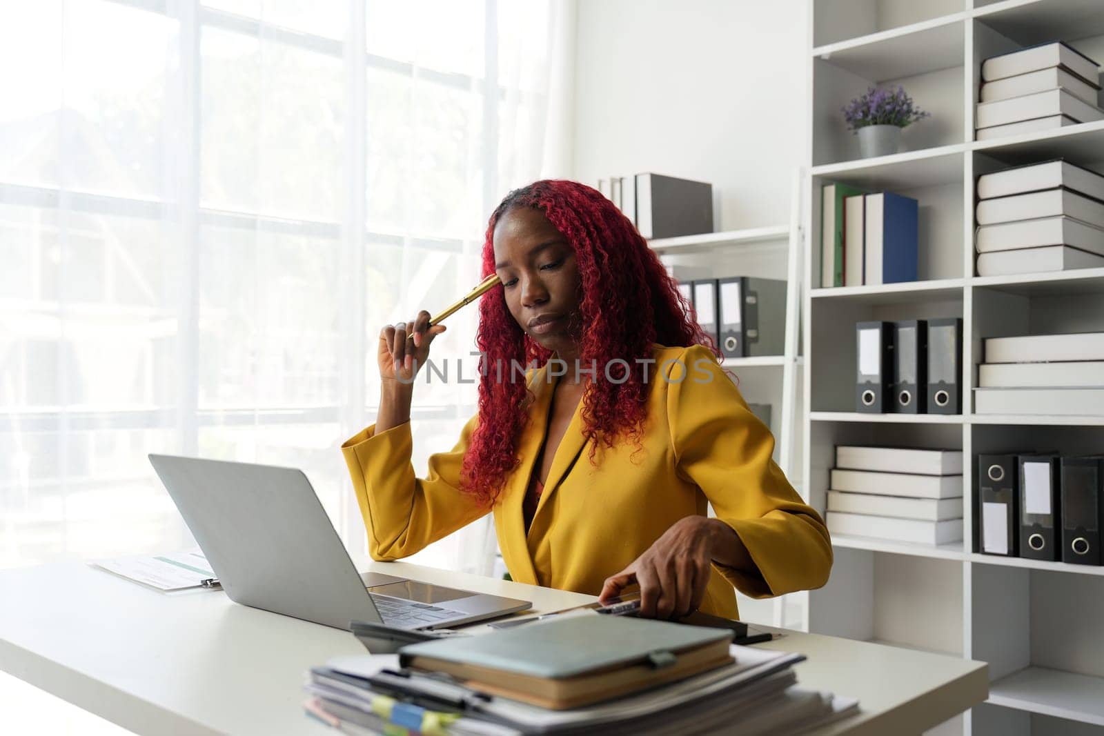 African american businesswoman working at office. Confident businesswoman sitting happily in the office.