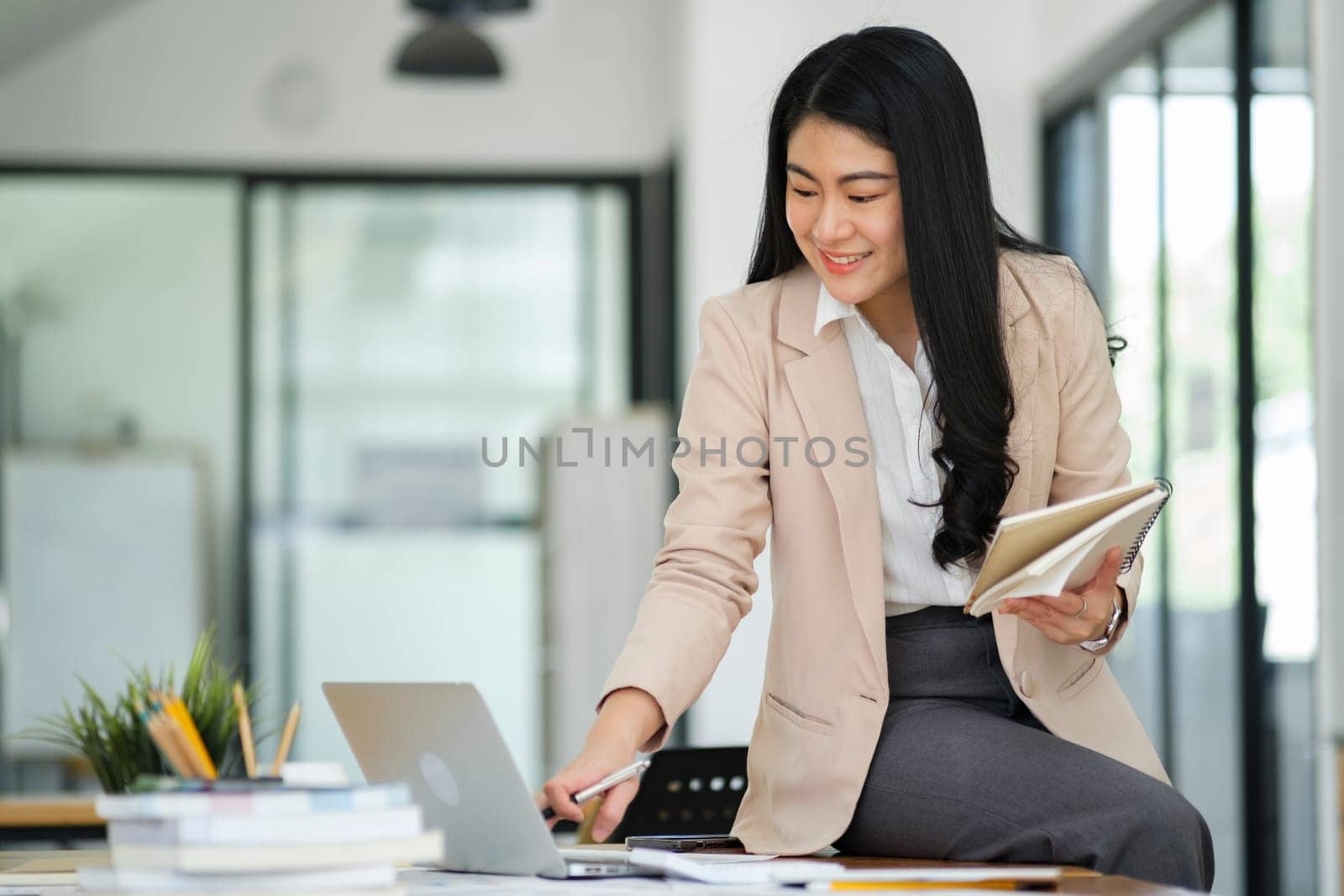 Businesswoman Analyzing Data on Laptop in Office. by ijeab