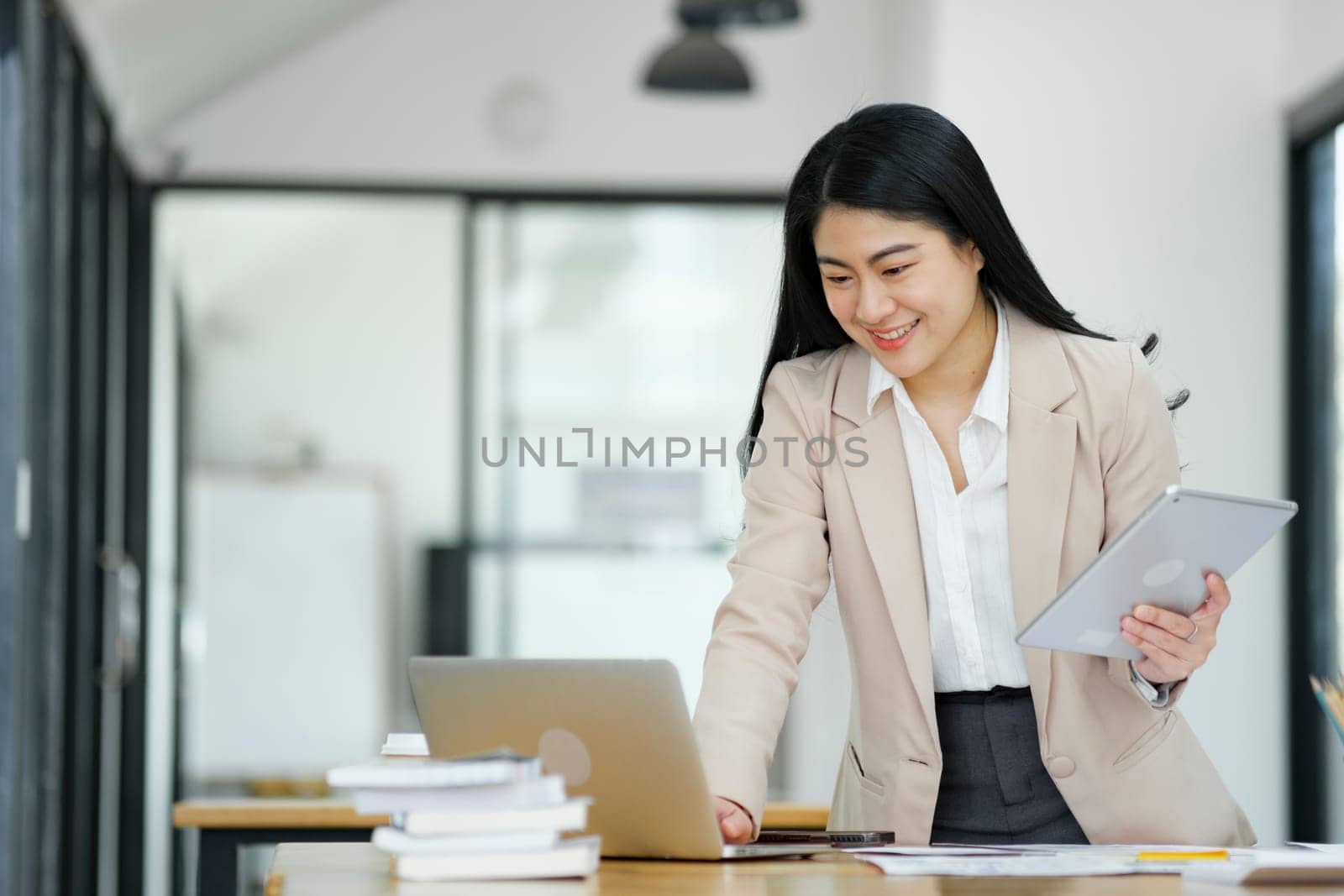 Businesswoman Analyzing Data on Laptop in Office. by ijeab