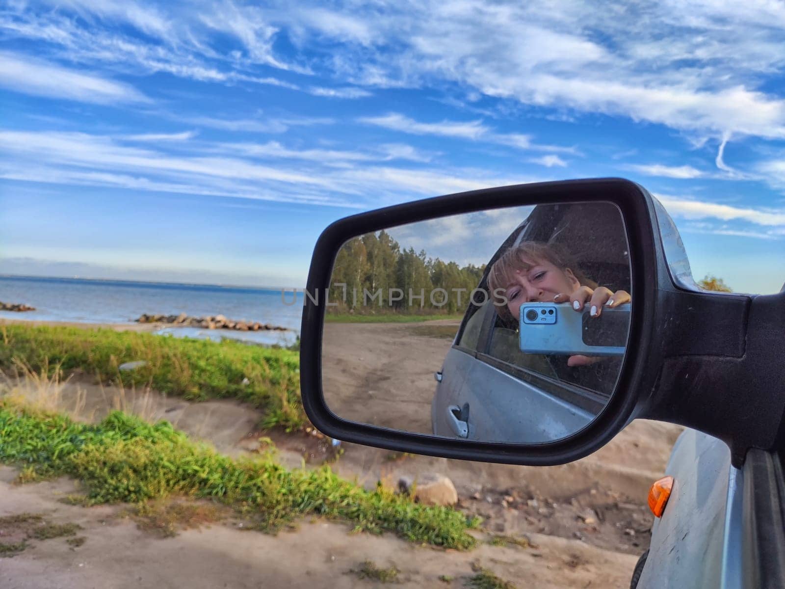 Self portrait at side view mirror of car in travel, trip on nature by keleny