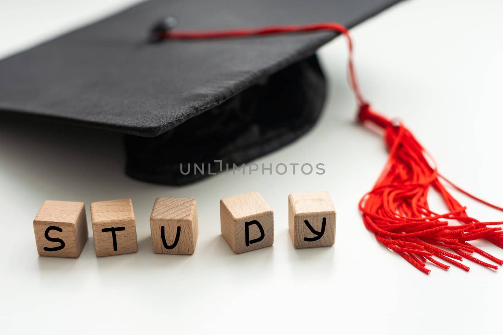 Graduation gap hat and wooden cubes, Education study testing learning teach concept. High quality photo