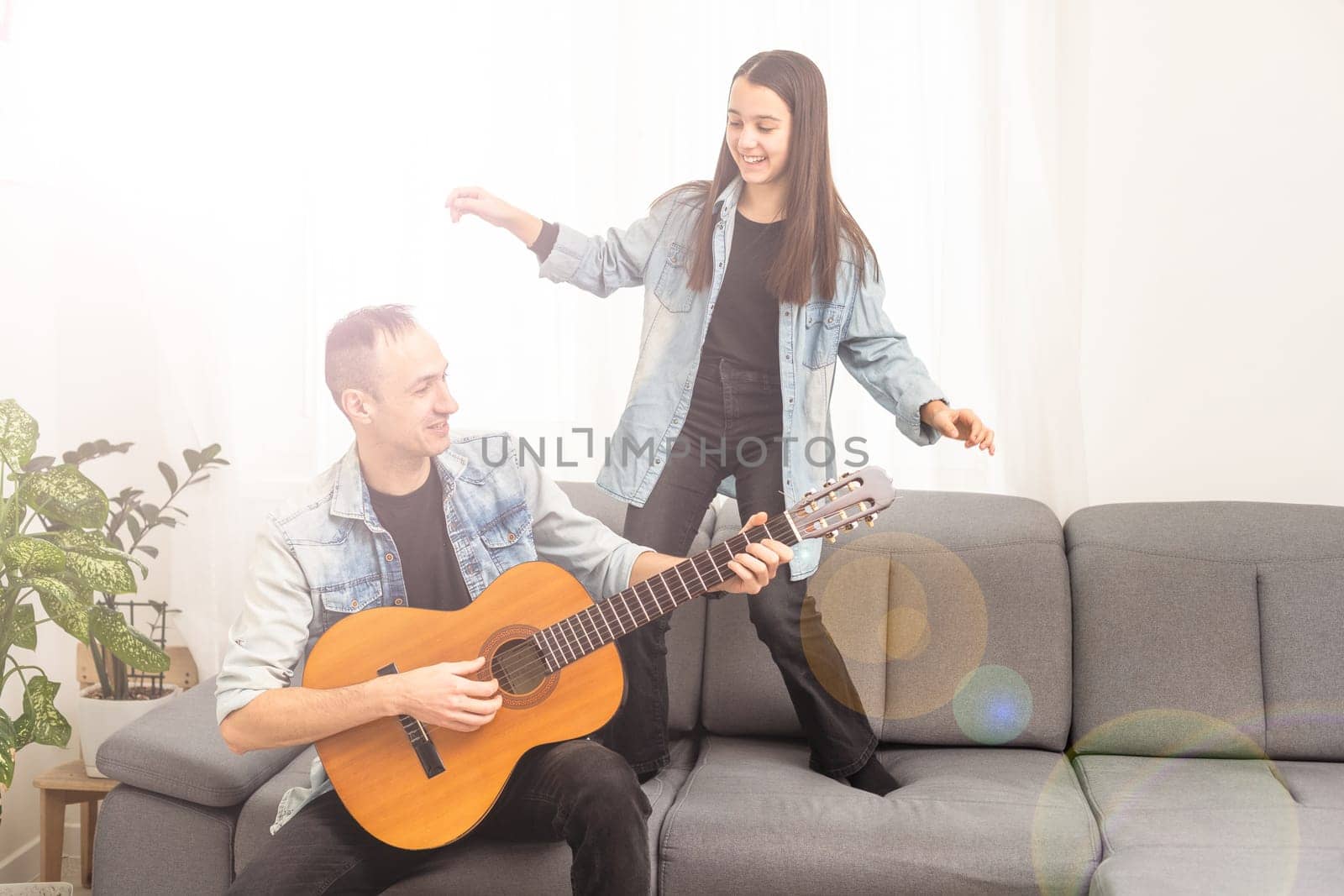 Happy family Father and daughter playing guitar. Father's day. High quality photo