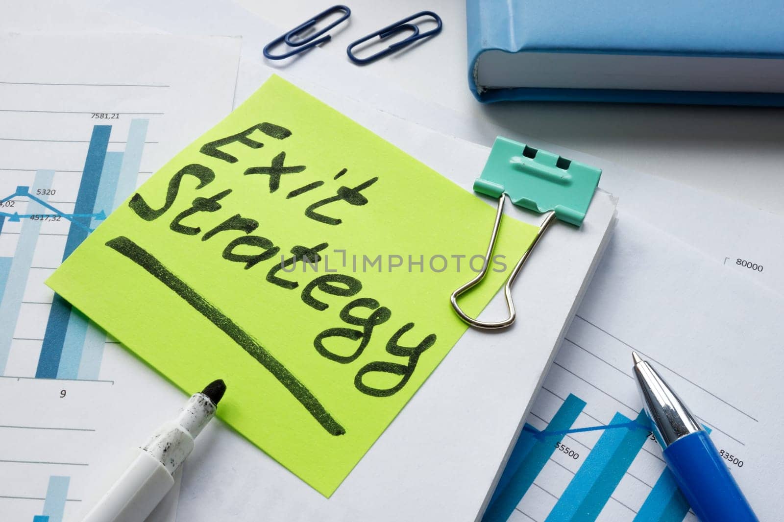 Business documents and note exit strategy on sticker. by designer491