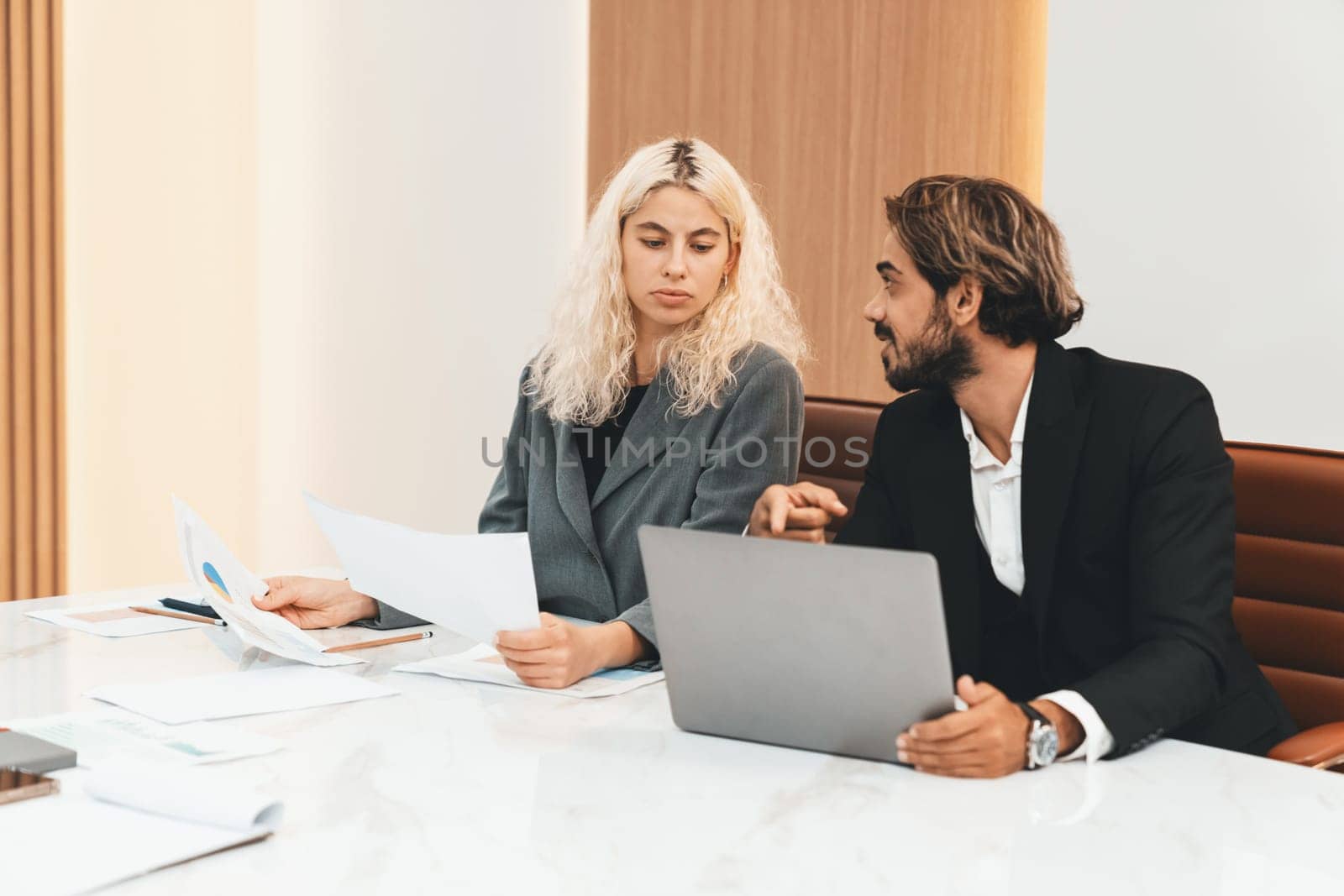 Corporate diverse businesspeople using laptop discussing marketing project during business meeting. Professional executive manager exchanging, sharing brainstorming creative business plan. Ornamented.
