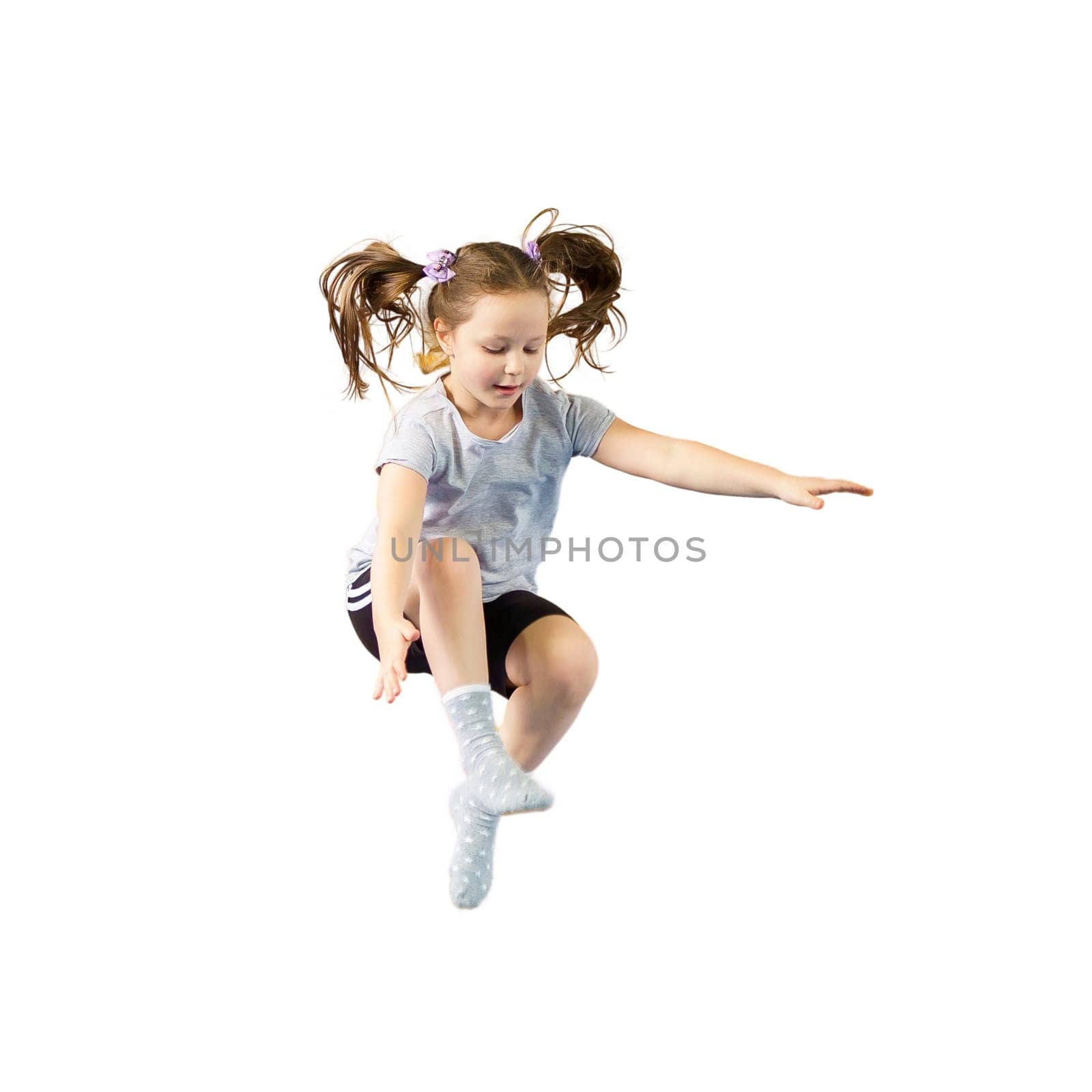 Happy little girl jumping isolated on white background by Mariakray