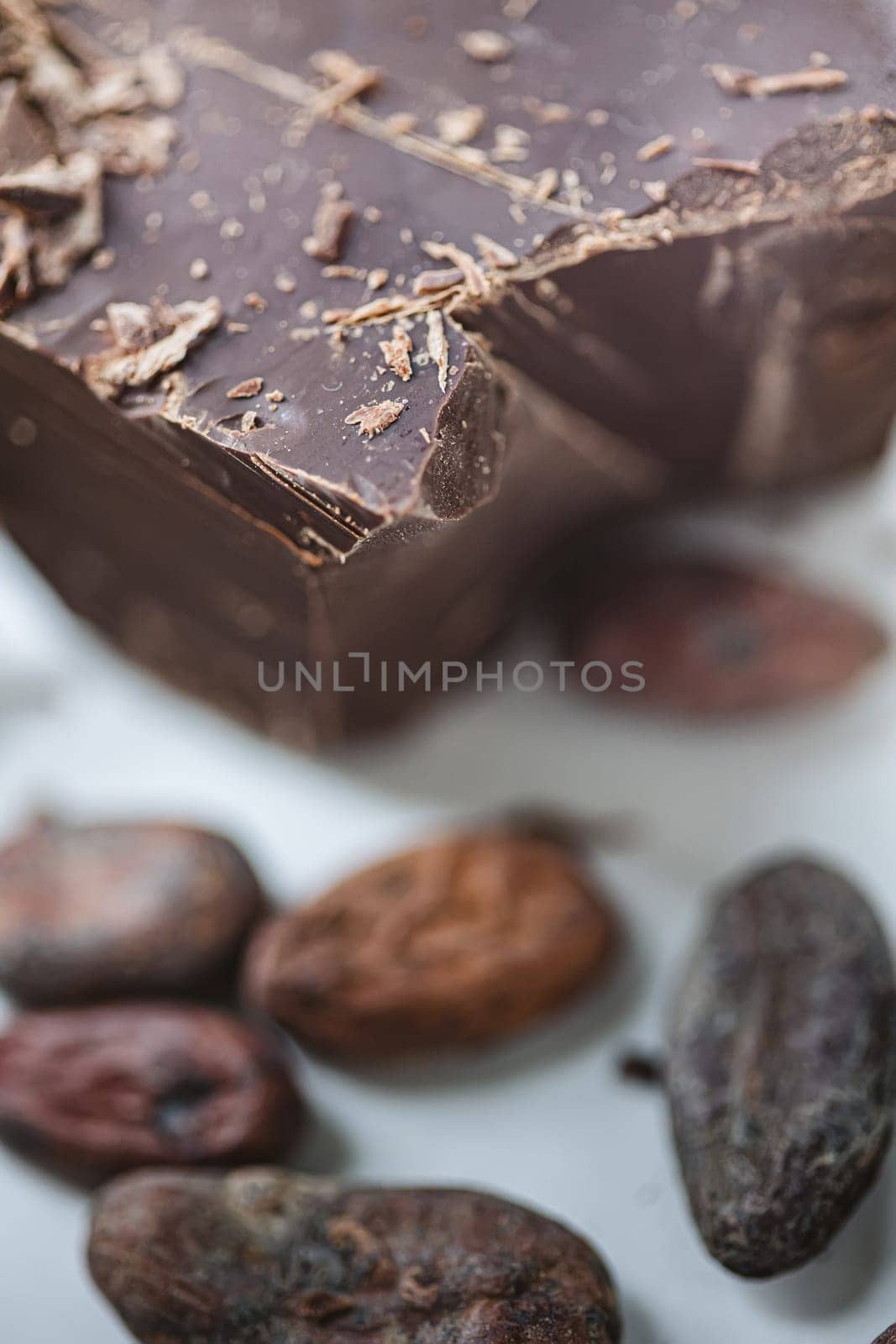 Cocoa beans with chocolate on a white background. Shalllow dof. Top view