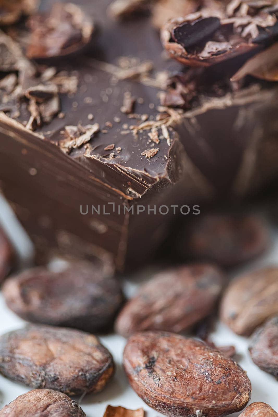 Cocoa beans with chocolate on a white background. Shalllow dof. by sarymsakov