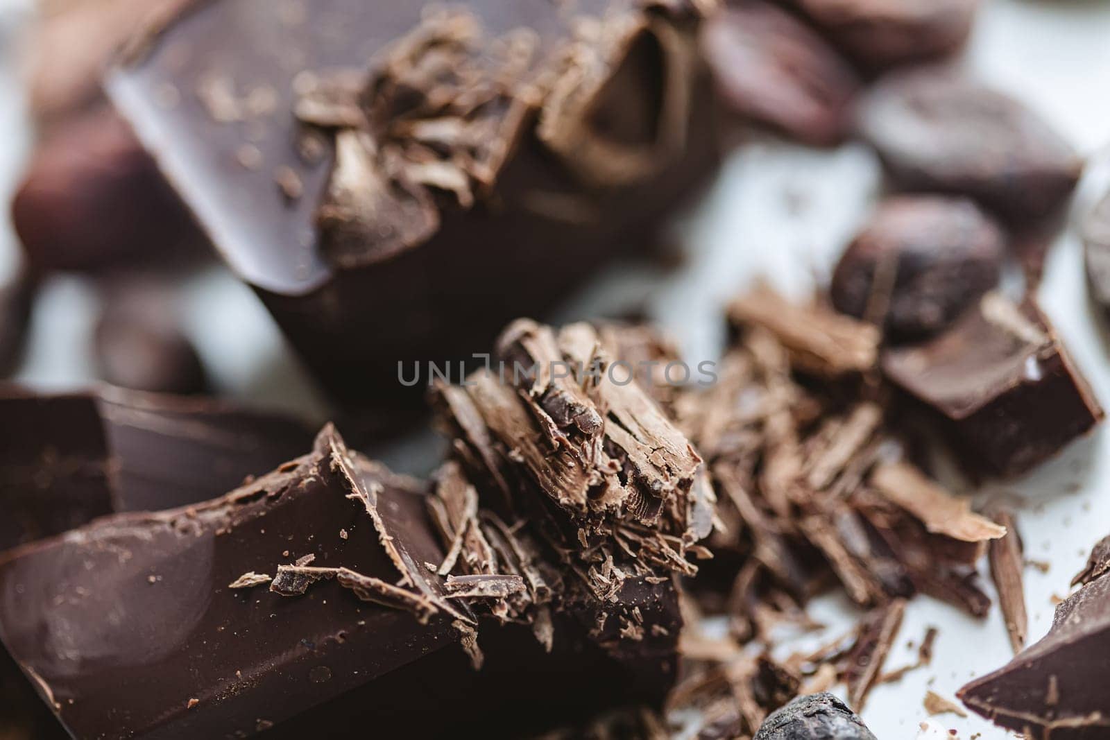 Cocoa beans with chocolate on a white background. Shalllow dof. Top view