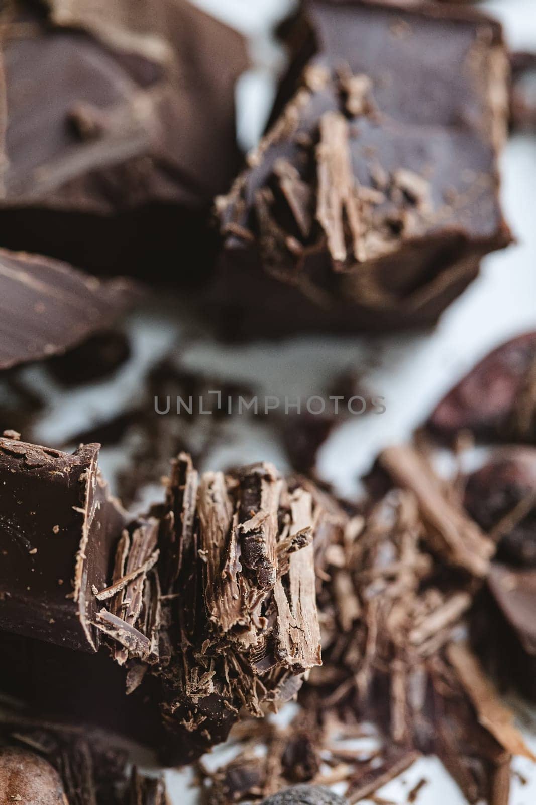 Cocoa beans with chocolate on a white background. Shalllow dof. Top view