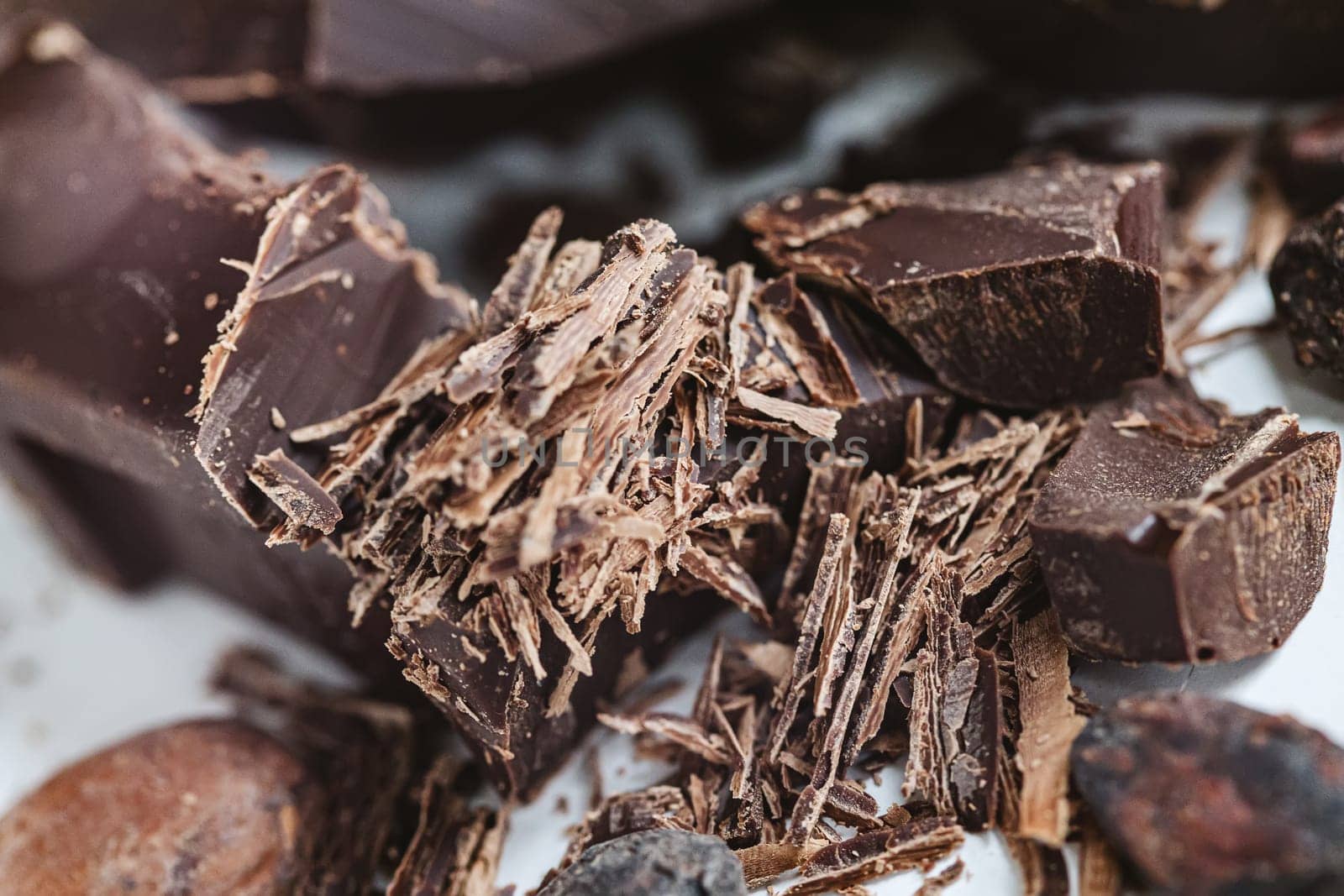 Cocoa beans with chocolate on a white background. Shalllow dof. Top view