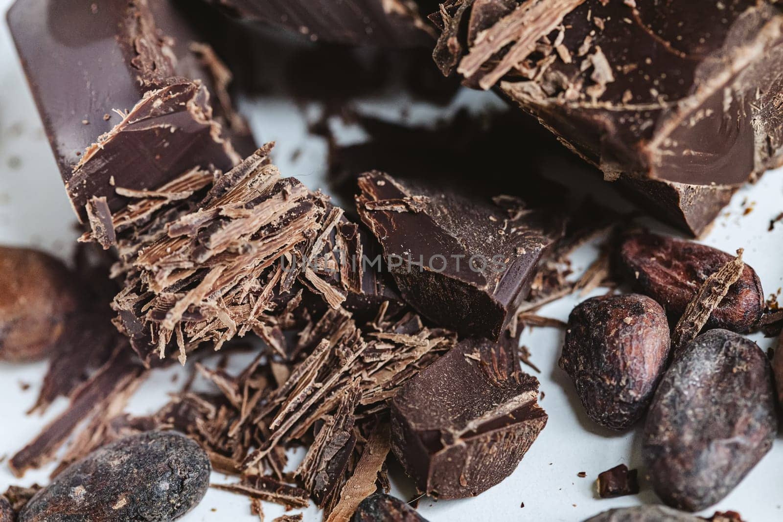 Cocoa beans with chocolate on a white background. Shalllow dof. Top view