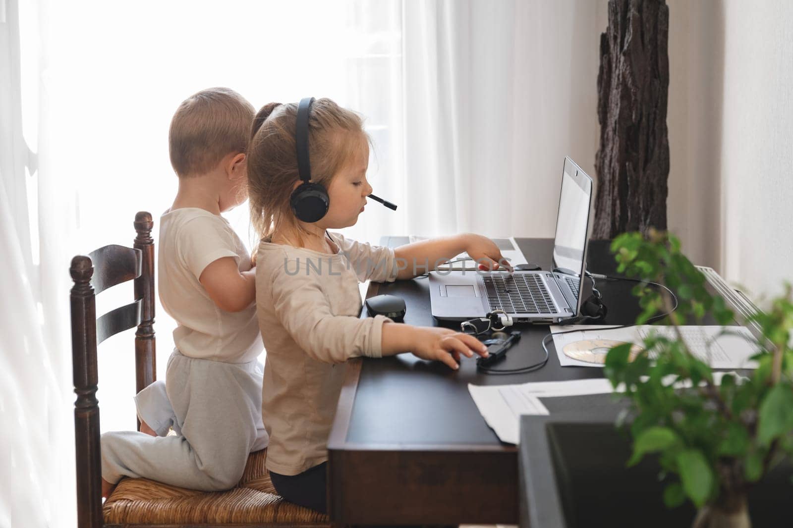 Little kids play with computer of parents