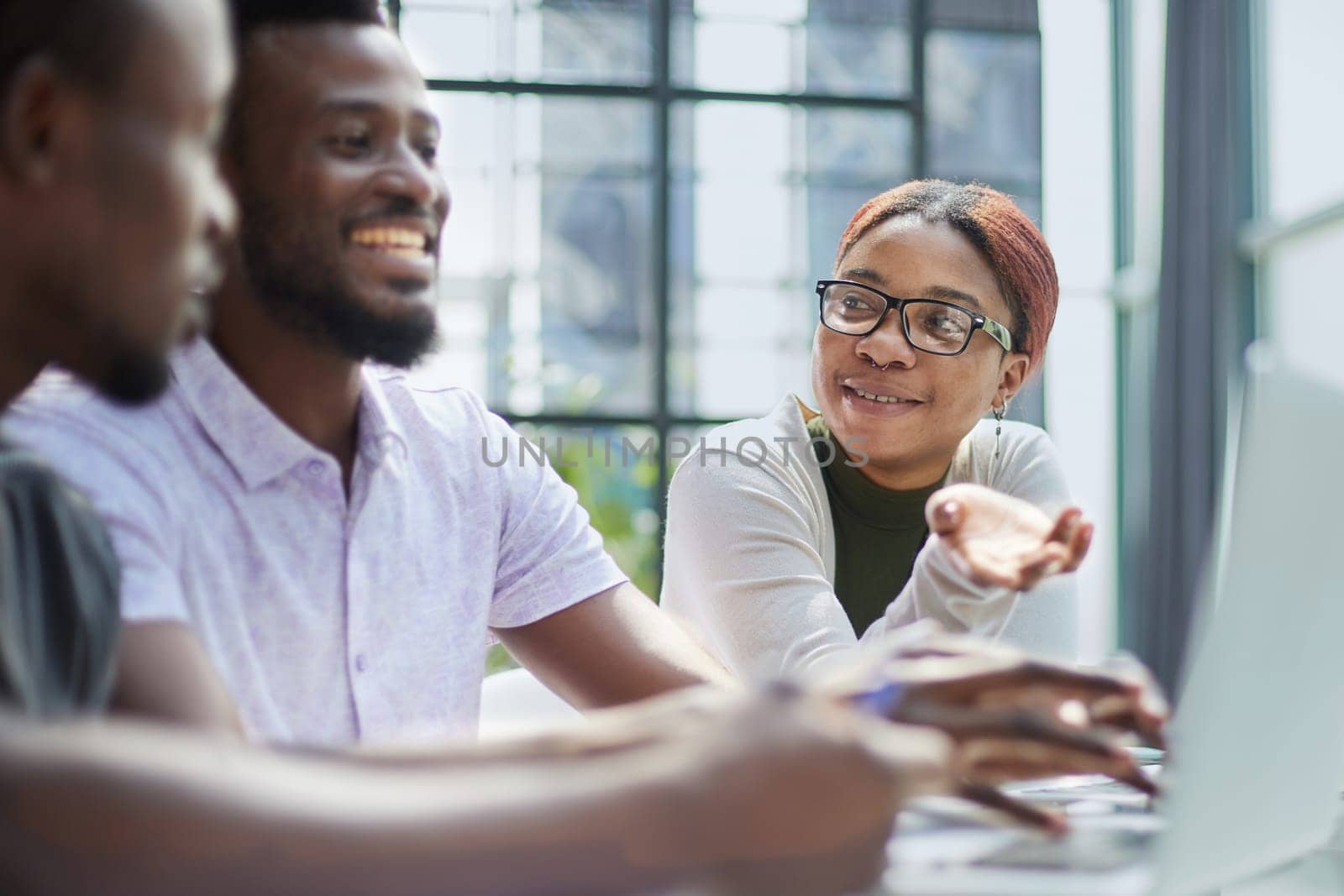 young guy uses the phone while sitting at the table in the office