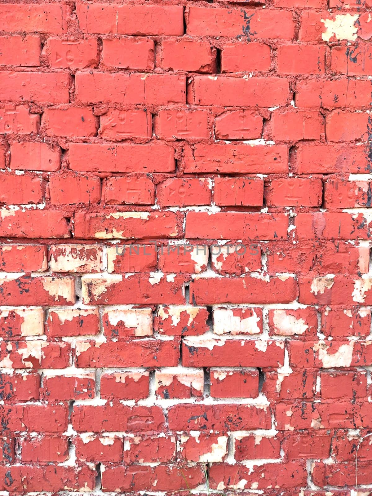 Colorful brick wall on the house. Texture of red stone blocks, close up. Background. by OnPhotoUa
