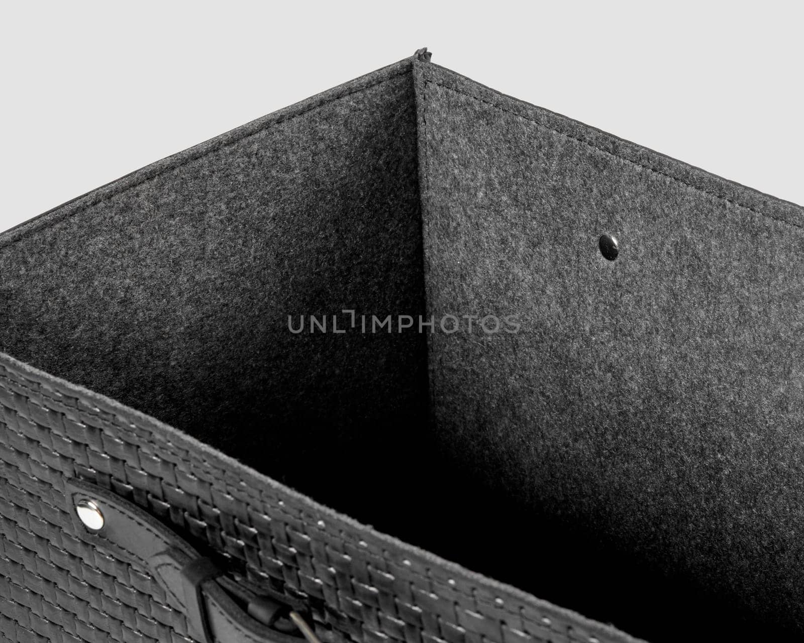 Closeup of black leather woven box with gray felt lining by nazarovsergey