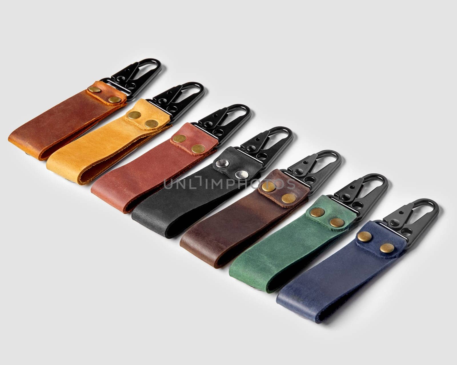 Handcrafted embossed leather keychains of various colors with carabiner clasps by nazarovsergey