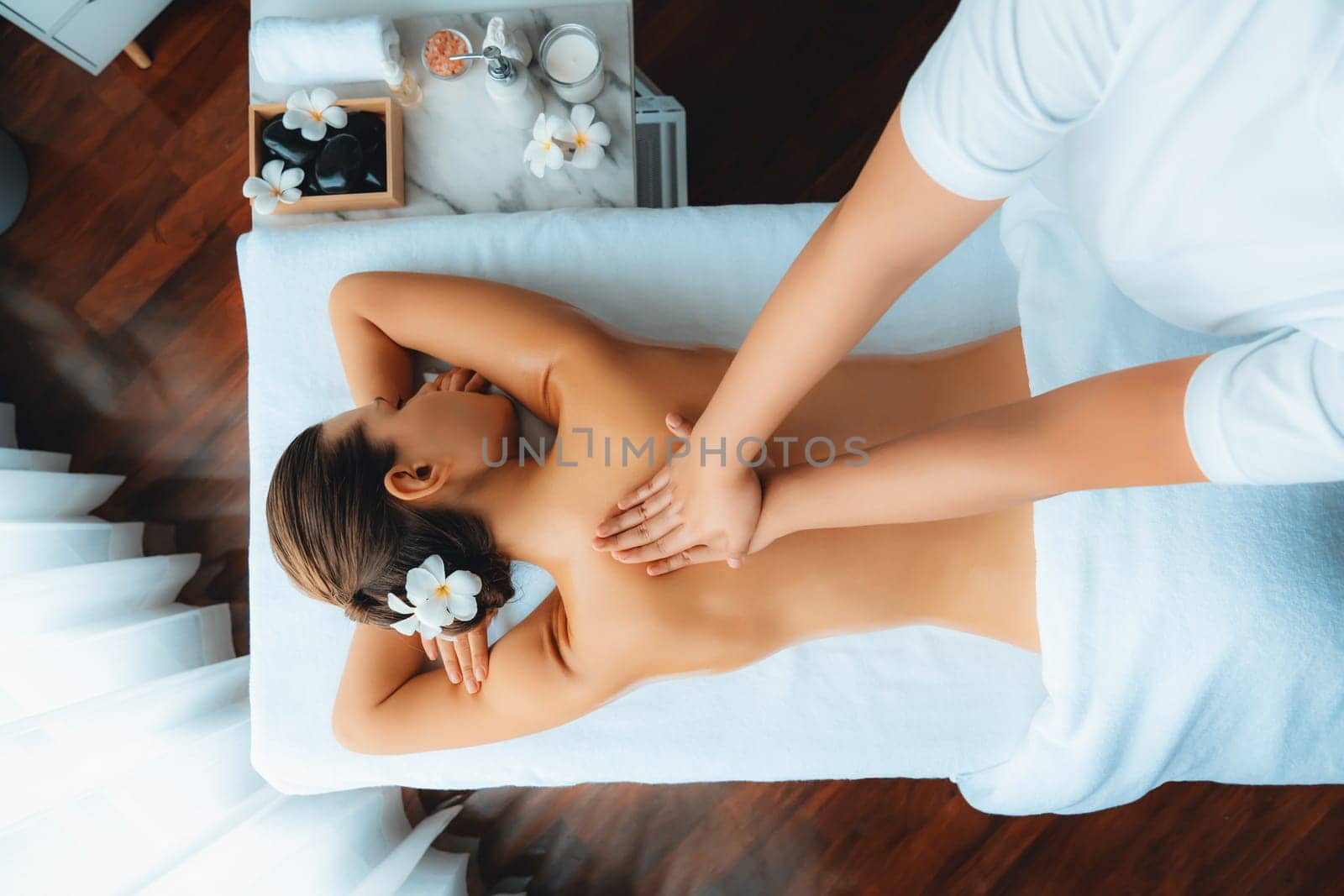 Panorama top view woman customer enjoying relaxing anti-stress spa massage and pampering with beauty skin recreation leisure in day light ambient salon spa at luxury resort or hotel. Quiescent