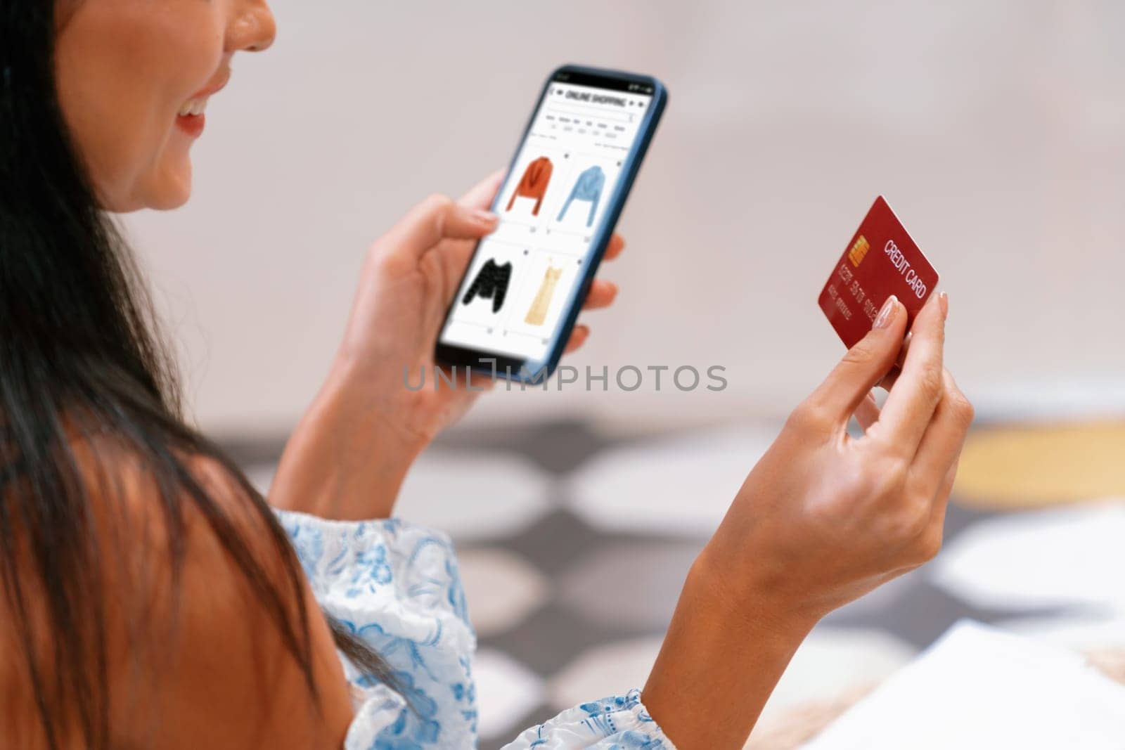 Young woman using smarpthone with credit card for internet banking, online shopping E commerce by online payment gateway at home. Modern and convenience online shopping with debit card. Blithe
