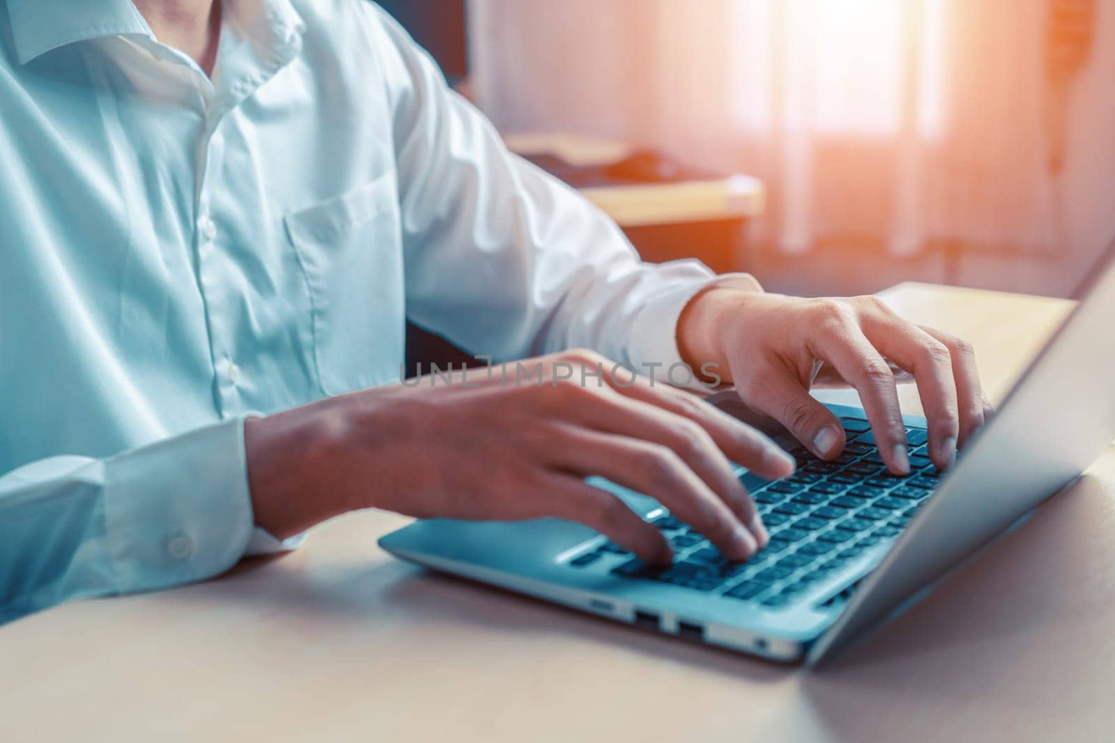 Businessman hand typing on computer keyboard of a laptop computer in office. Business and finance concept. uds