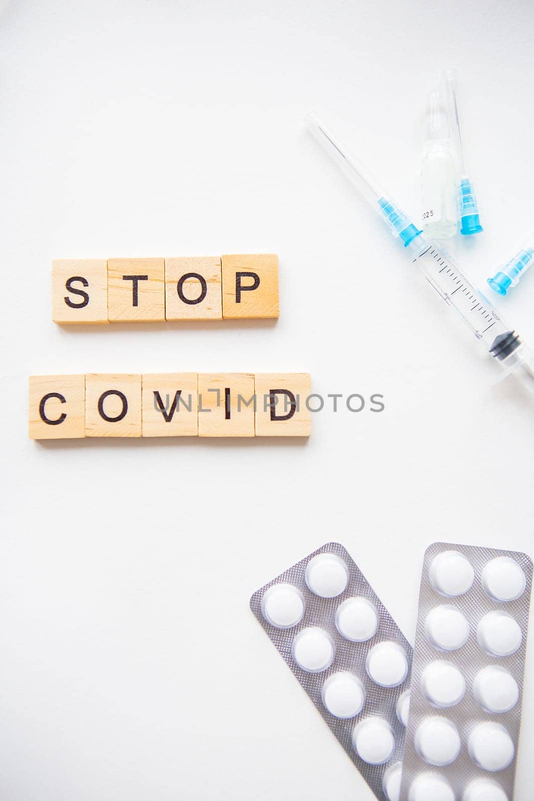 Stop coronavirus inscription. Preparation for vaccination against covid-19. Syringe, vaccine, pills, medical mask