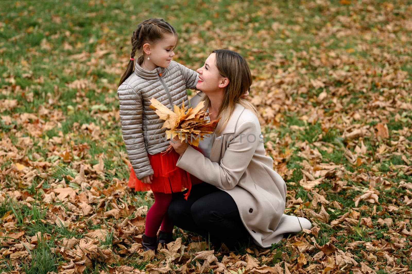 Autumn portrait of a mother with her daughter in the park. by Niko_Cingaryuk