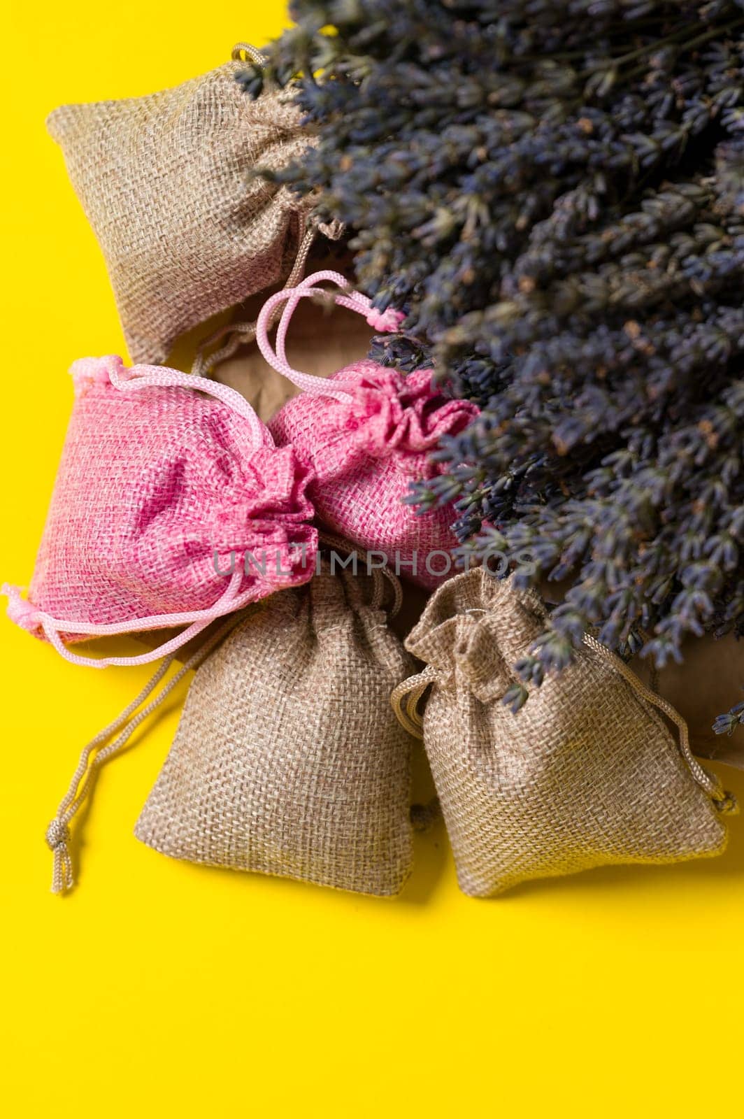 Dried lavender flowers and sachets on a yellow background. by Niko_Cingaryuk