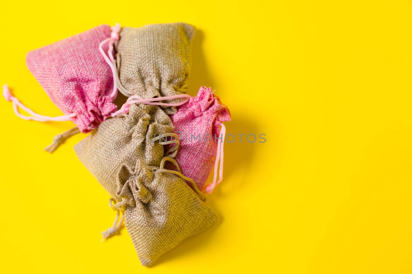 Lavender flower in a linen bag on a yellow background. by Niko_Cingaryuk