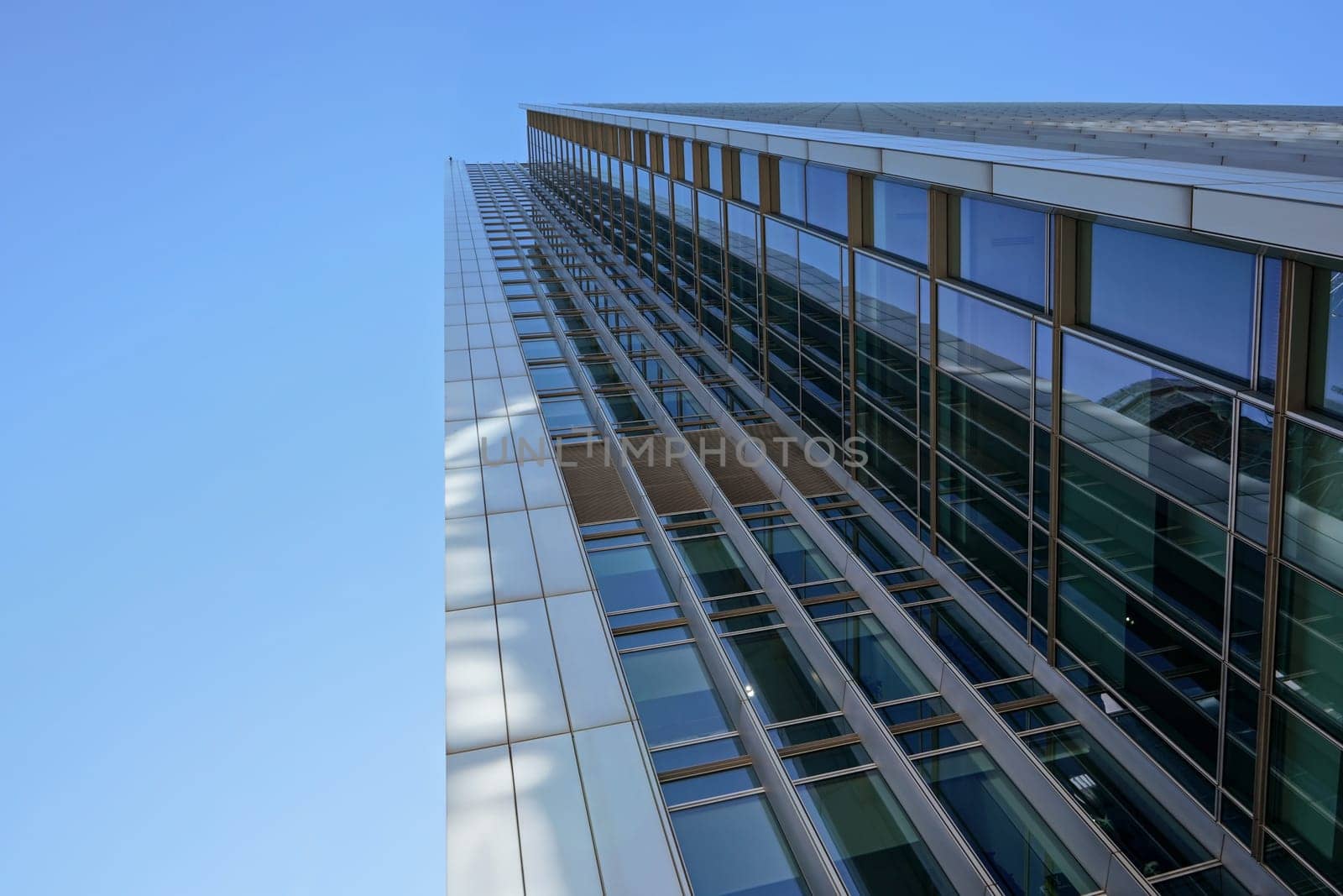 London, United Kingdom - February 03, 2019: Looking up glass and steel "10 Upper Bank Street" skyscraper at Canary Wharf. It's one of tallest buildings in UK capital, designed by Kohn Pendersen Fox by Ivanko