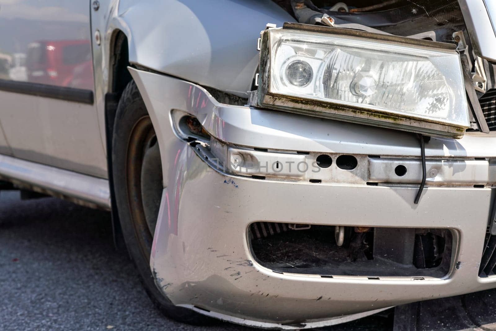 Closeup of broken headlight on crashed car after road accident
