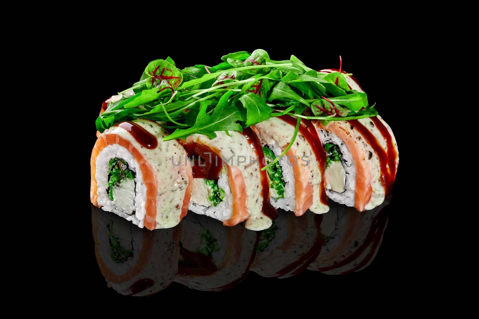 Sushi rolls with cream cheese, hiyashi wakame, salmon served with greens by nazarovsergey