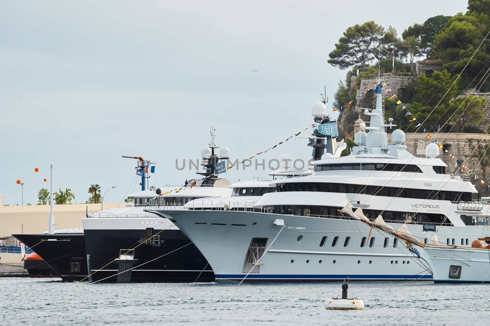 Monaco, Monte Carlo, 29 September 2022 - a lot of luxury yachts at the famous motorboat exhibition at sunset, the most expensive boats for the richest people, yacht brokers, boat traffic. High quality photo
