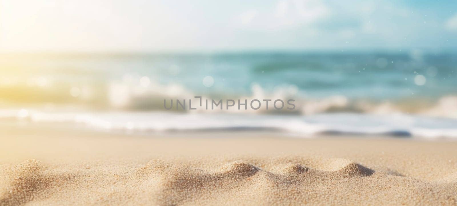 Close-up of a tranquil sandy beach with a soft-focus ocean in the background and particles glistening.