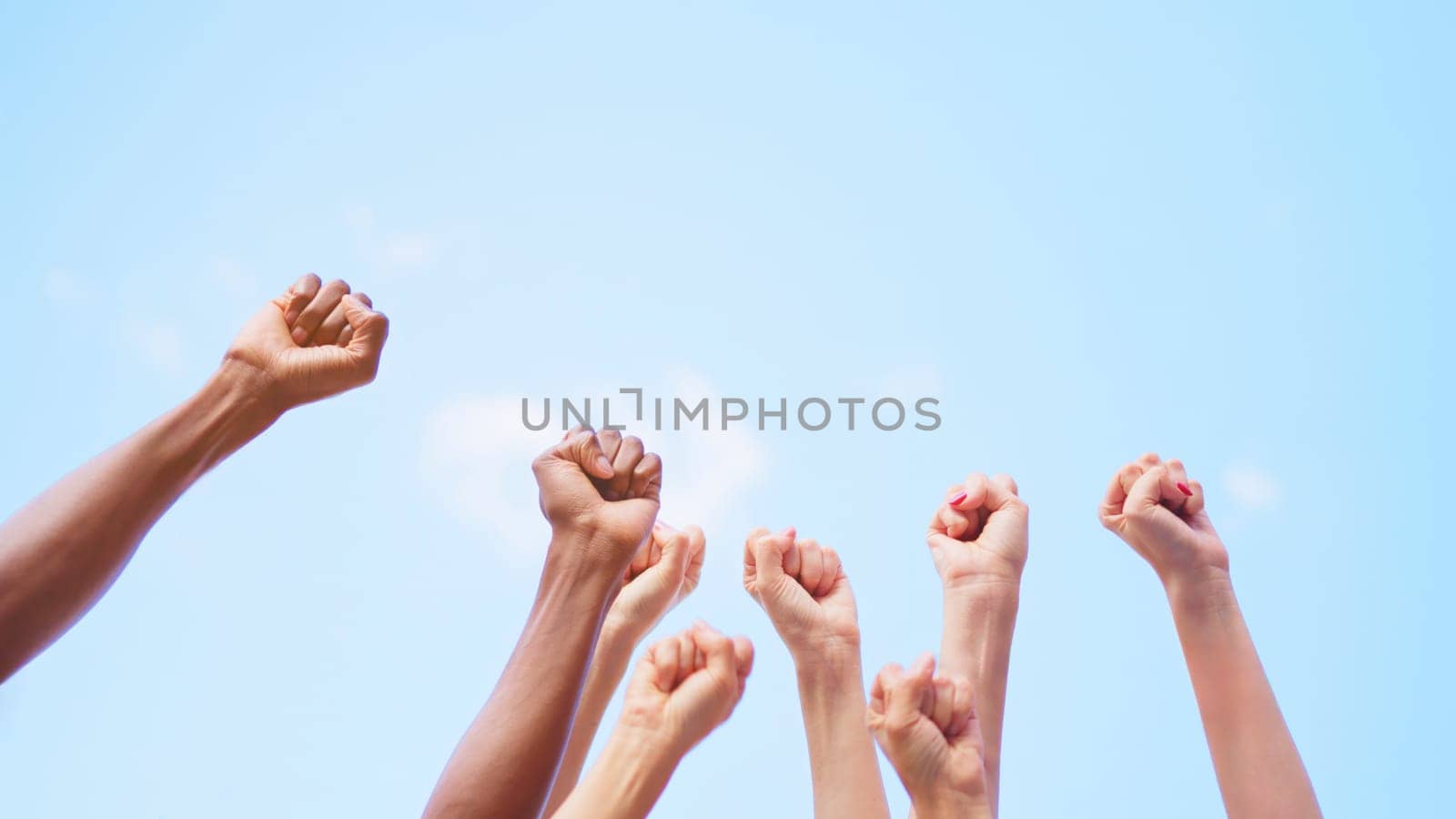 Different fists of people waving in the air by ivanmoreno