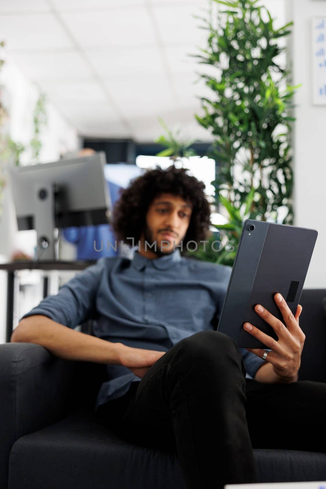 Businessman teleworking using videocall app on digital tablet by DCStudio