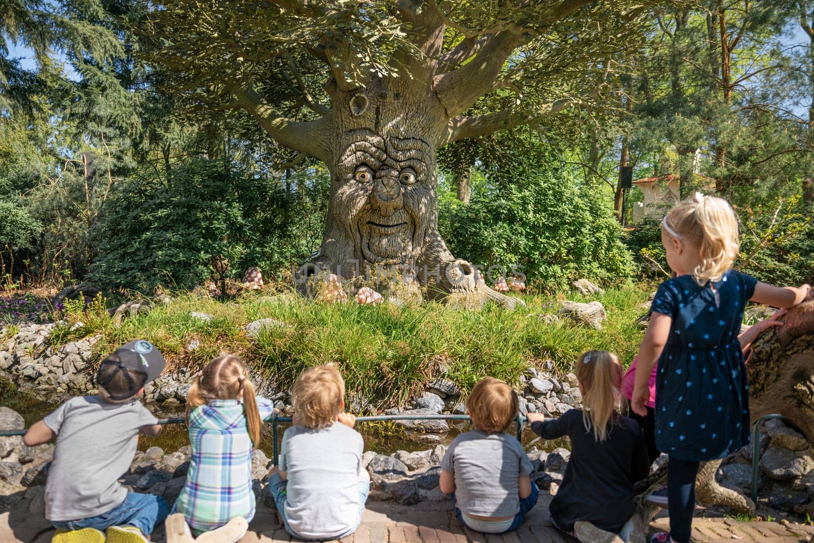 KAATSHEUVEL, NETHERLANDS - APRIL 19, 2019: An old tree tells children legends and fairy tales. by Godi