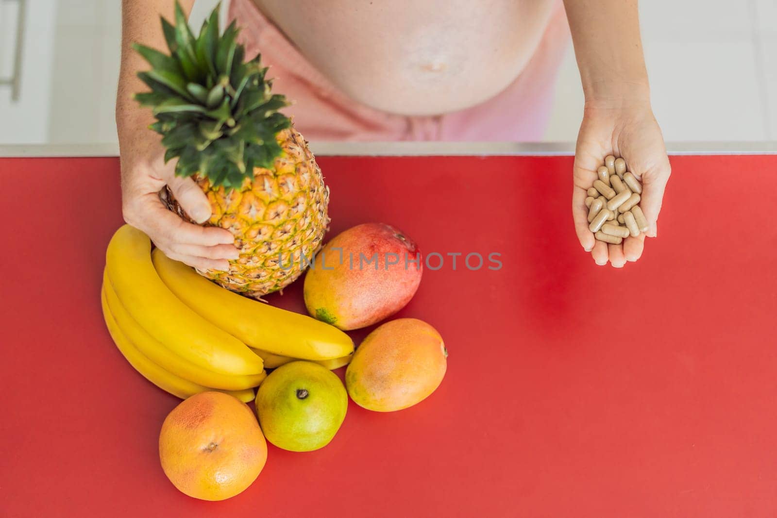 Balancing choices for optimal nutrition, a pregnant woman decides between the wholesome goodness of fresh fruits and the convenience of vitamin tablets, ensuring a well-rounded approach to her prenatal health by galitskaya