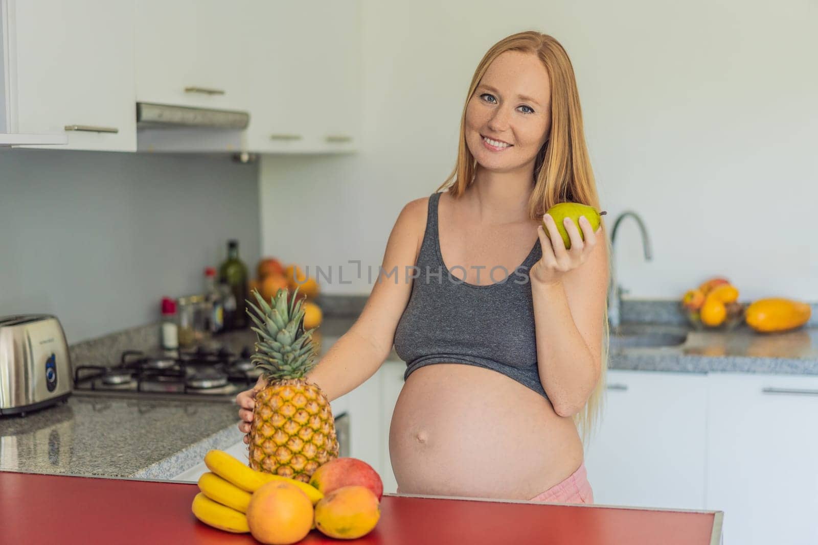 Embracing a healthy choice, a pregnant woman prepares to enjoy a nutritious moment, gearing up to eat fresh fruit and nourish herself during her pregnancy by galitskaya