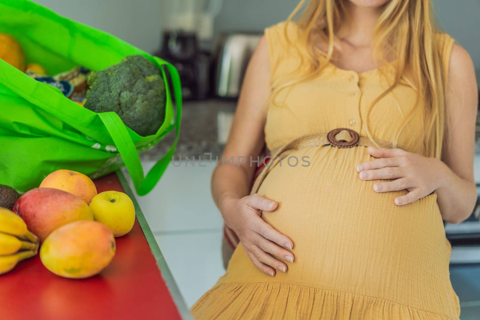 Exhausted but resilient, a pregnant woman feels fatigue after bringing home a sizable bag of groceries, showcasing her dedication to providing nourishing meals for herself and her baby by galitskaya