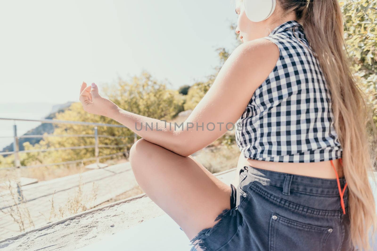 Woman laptop sea. Working remotely on seashore. Happy successful woman female freelancer working on laptop by the sea at sunset, makes a business transaction online. Freelance, remote work on vacation by panophotograph