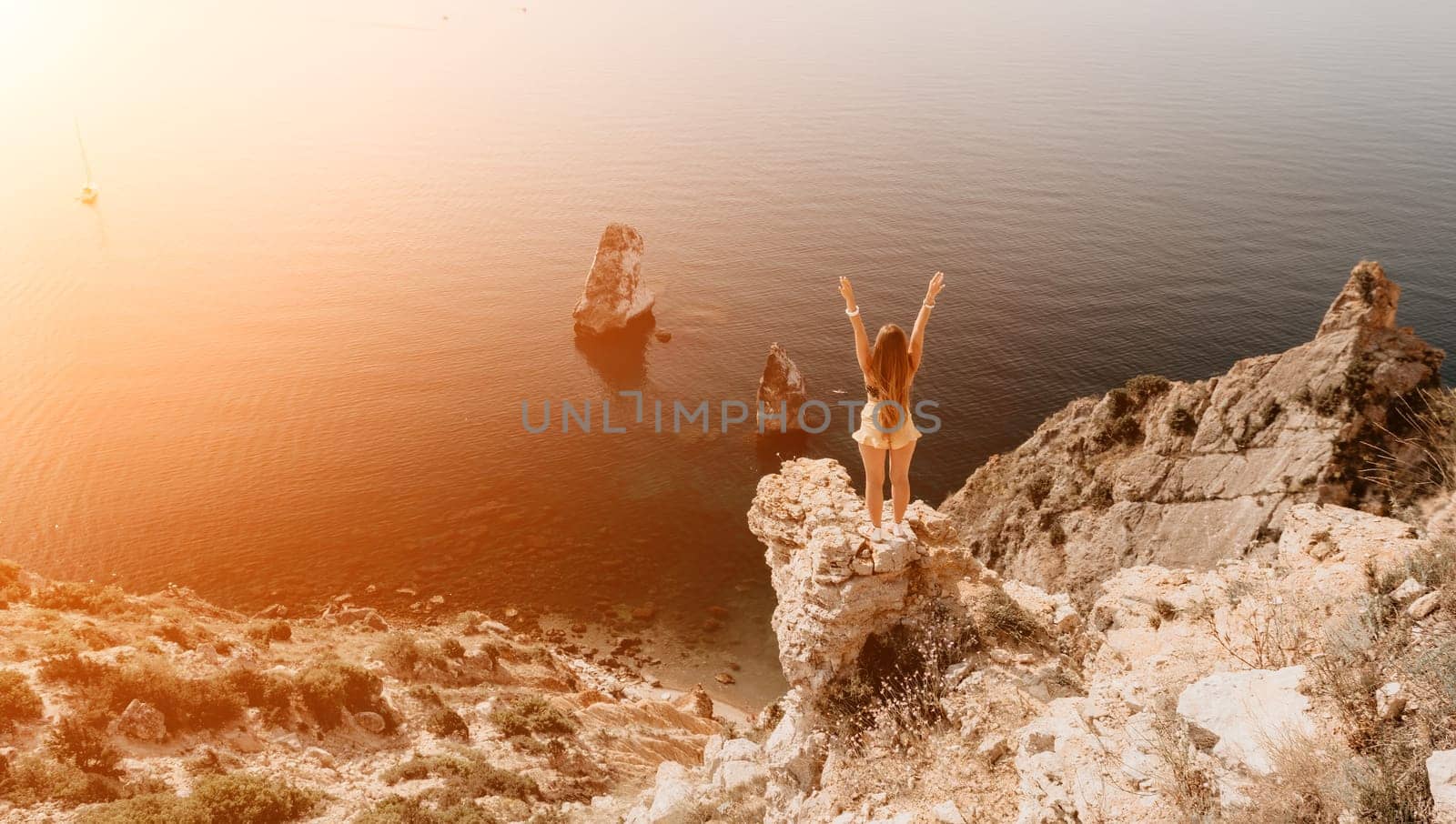 Woman travel sea. Happy tourist enjoy taking picture outdoors for memories. Woman traveler looks at the edge of the cliff on the sea bay of mountains, sharing travel adventure journey by panophotograph